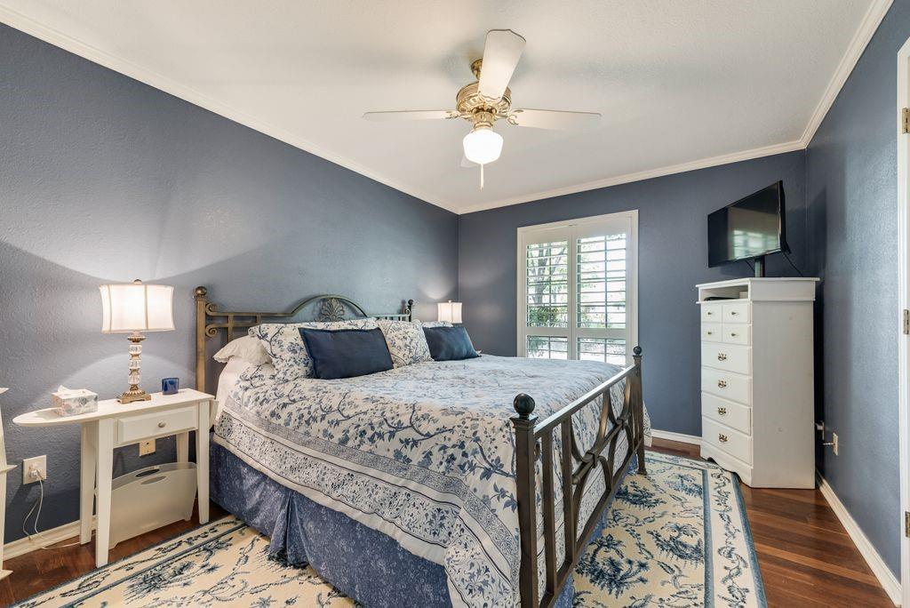 802 Riva Ridge Wylie, TX 75098 - Photo 25 of 39 a bedroom with a bed and a chandelier