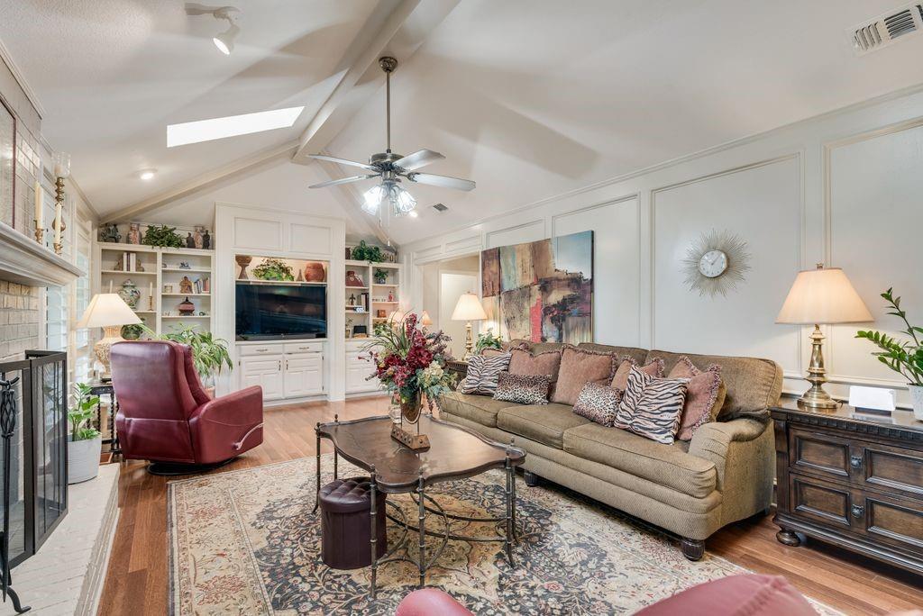 802 Riva Ridge Wylie, TX 75098 - Photo 6 of 39 a living room with furniture a flat screen tv and a fireplace