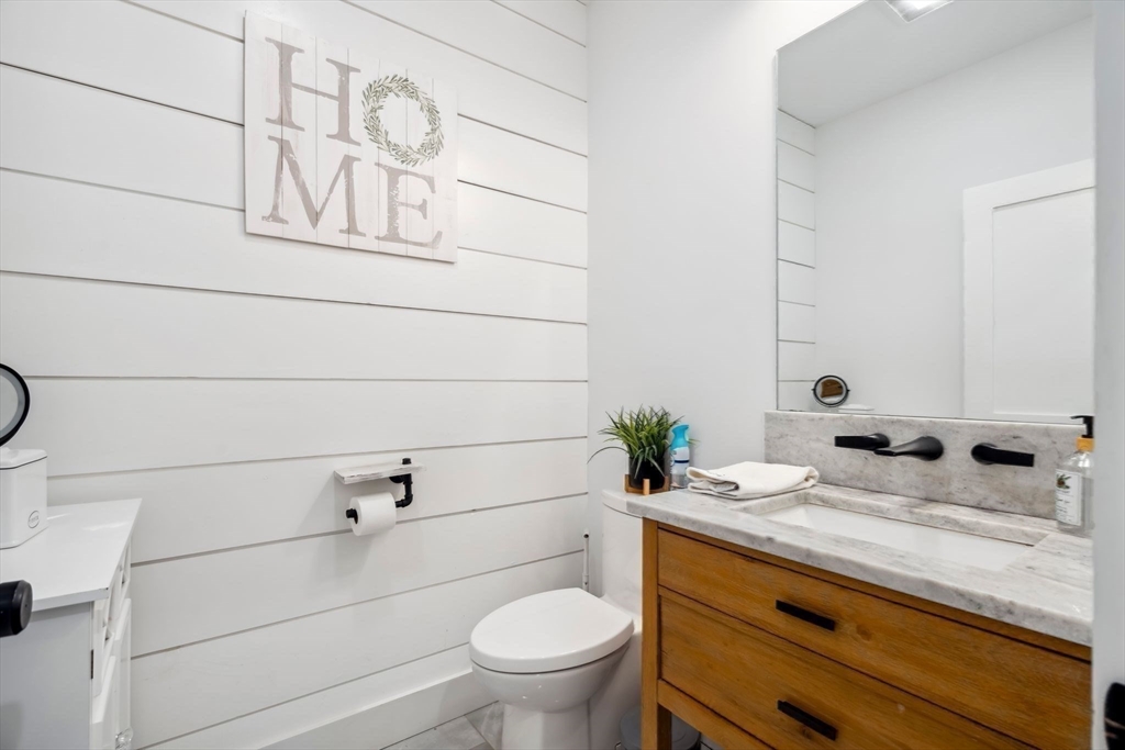 58 Folly Mill Road Salisbury, MA 01952 - Photo 11 of 31 a bathroom with a granite countertop toilet sink and mirror