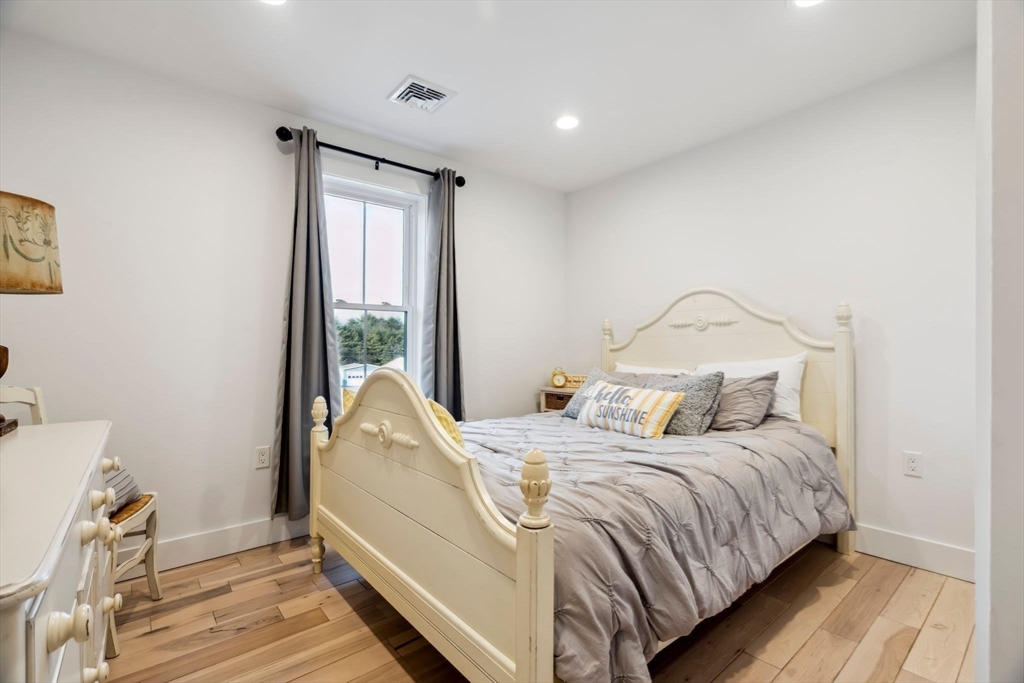 58 Folly Mill Road Salisbury, MA 01952 - Photo 21 of 31 a bedroom with a bed and wooden floor