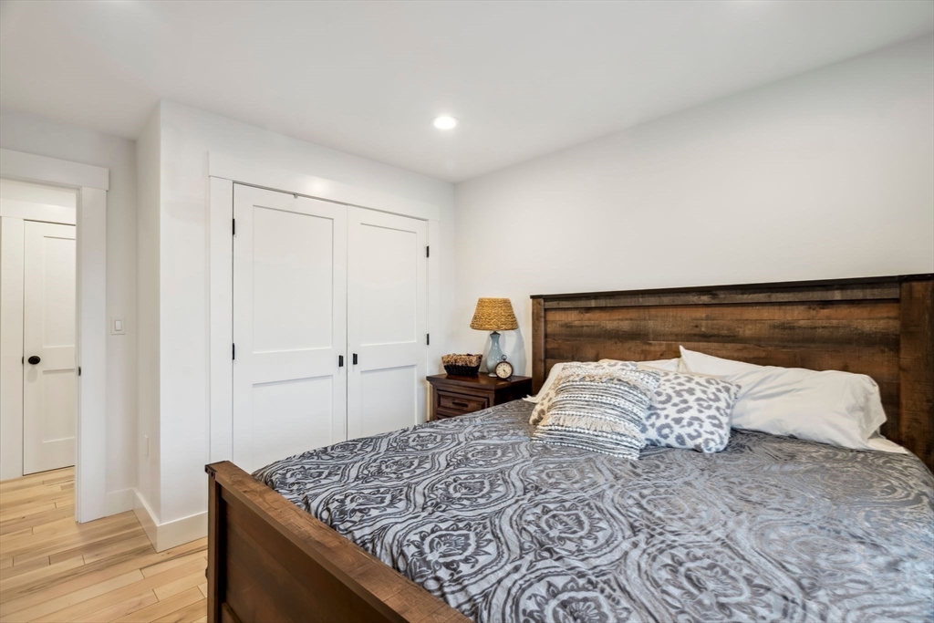 58 Folly Mill Road Salisbury, MA 01952 - Photo 22 of 31 a bedroom with a bed and wooden floor