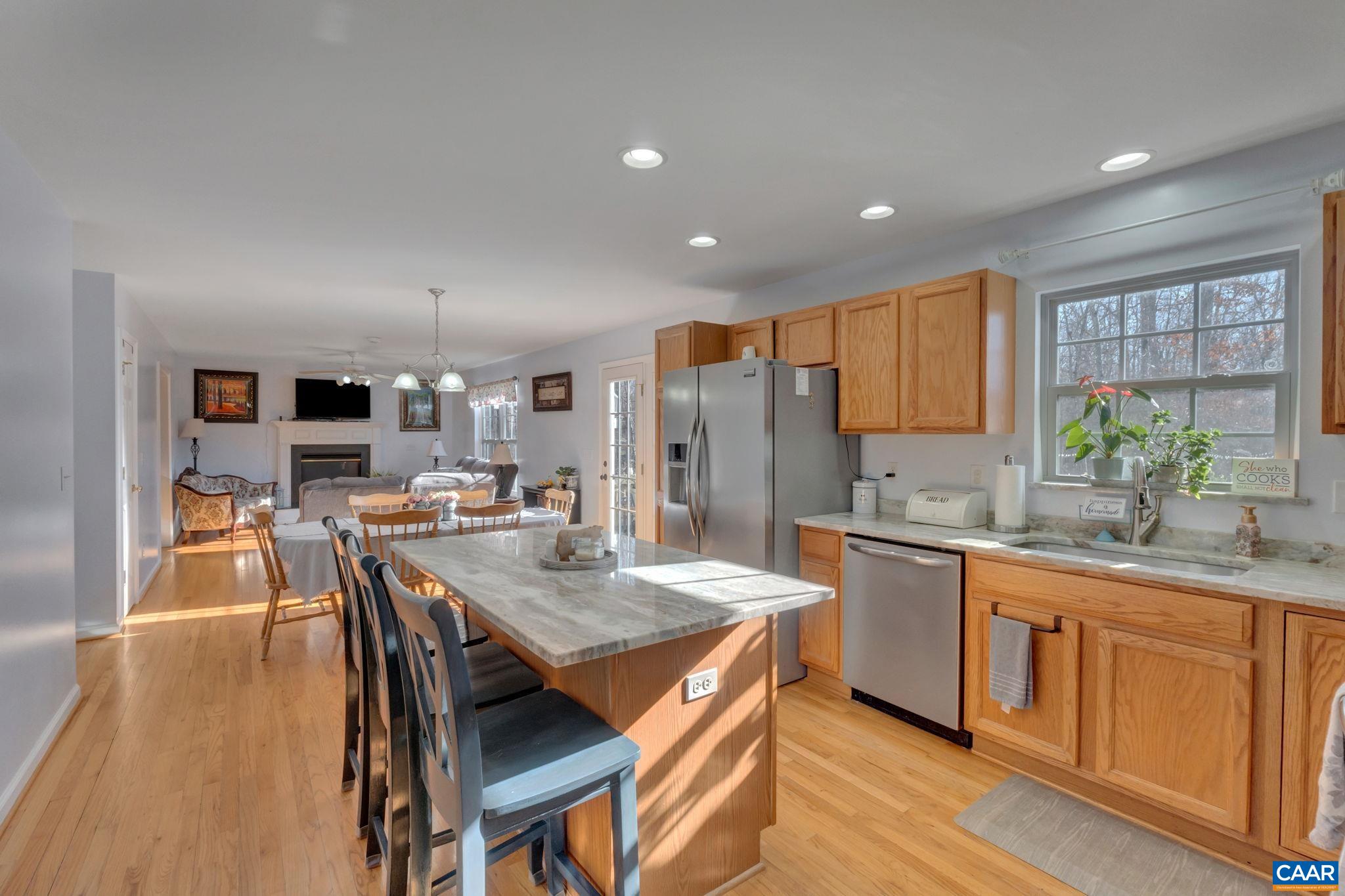 70 Laguna Road Palmyra, VA 22963 - Photo 11 of 33 a kitchen with stainless steel appliances granite countertop a kitchen island hardwood floor sink stove dining table and chairs