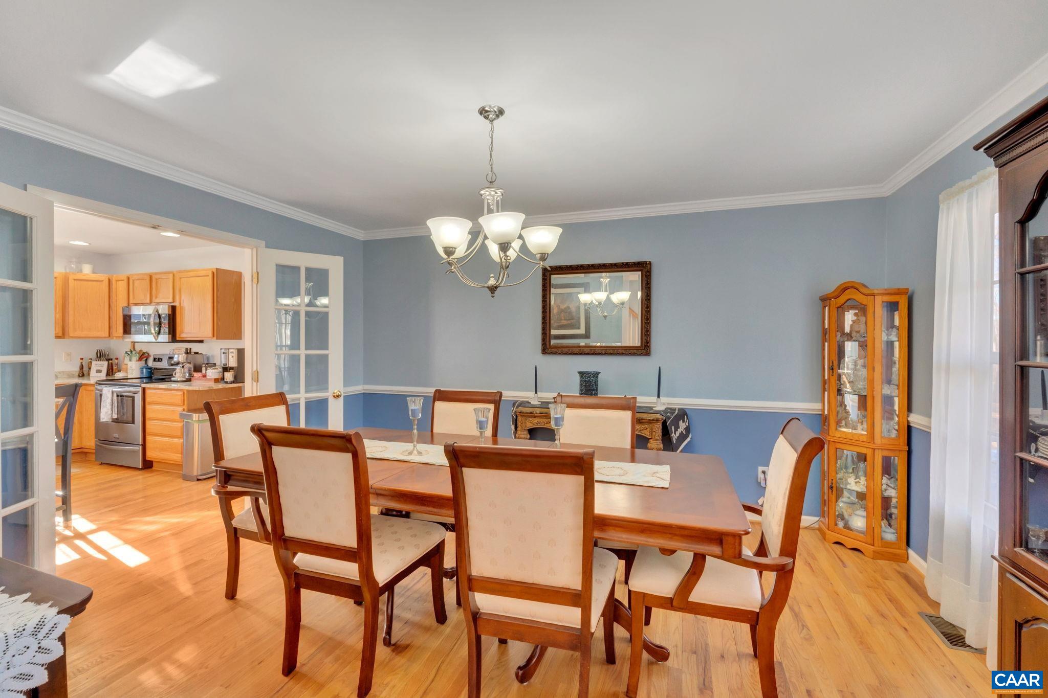 70 Laguna Road Palmyra, VA 22963 - Photo 14 of 33 a dining room with furniture a chandelier and wooden floor
