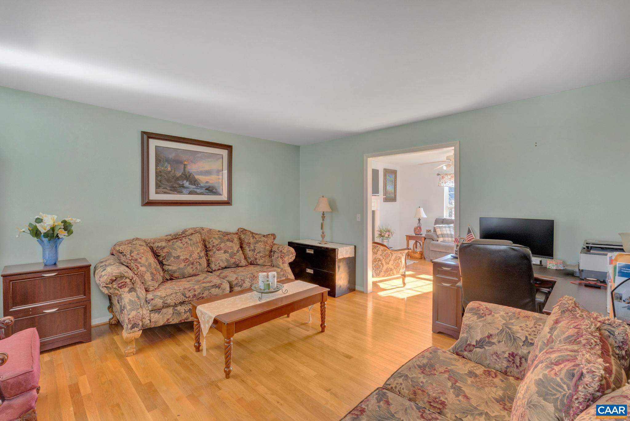 70 Laguna Road Palmyra, VA 22963 - Photo 15 of 33 a living room with furniture a couch and paintings on the wall