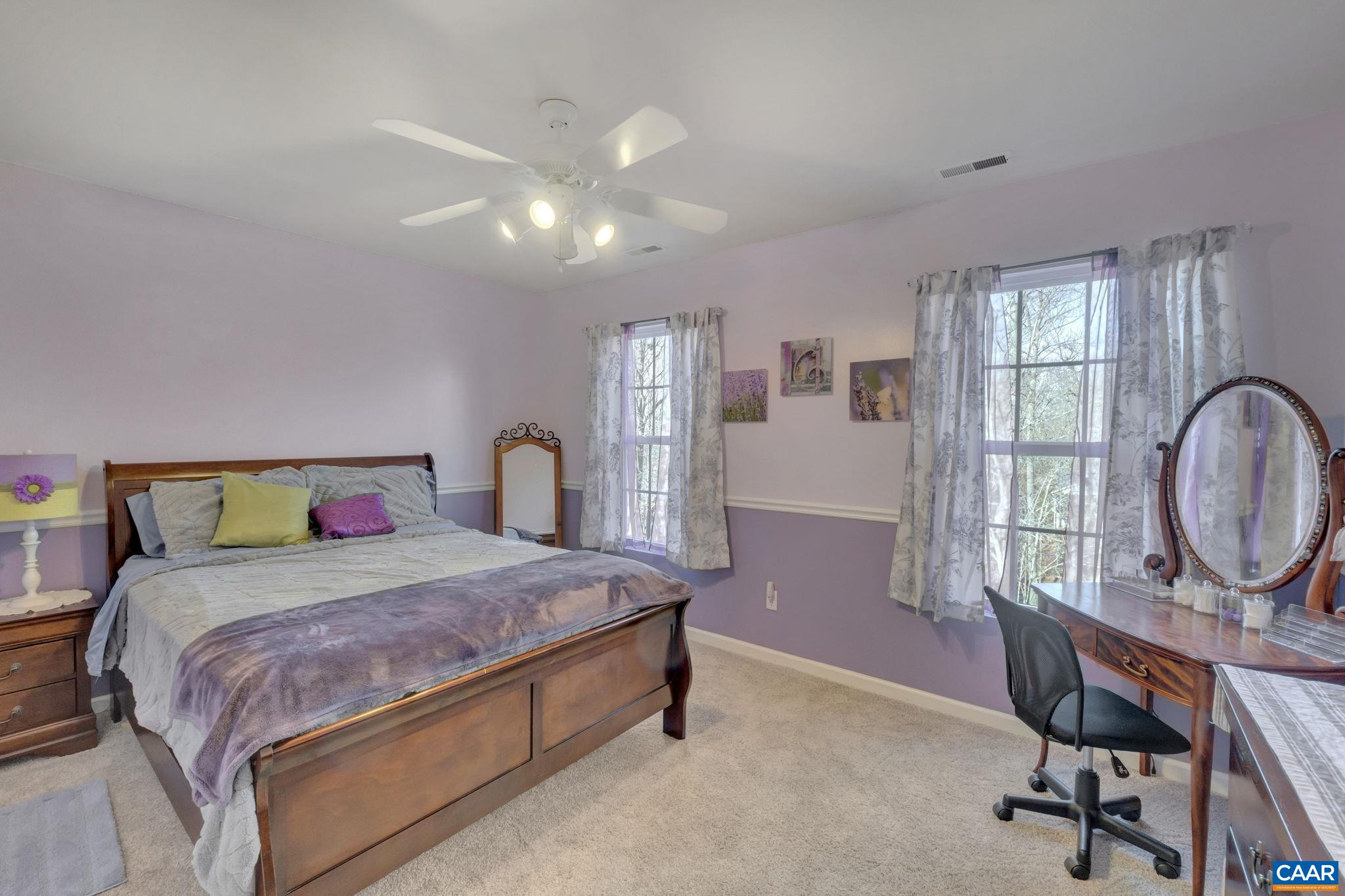 70 Laguna Road Palmyra, VA 22963 - Photo 20 of 33 a bedroom with a bed a desk and chair with a bookshelf