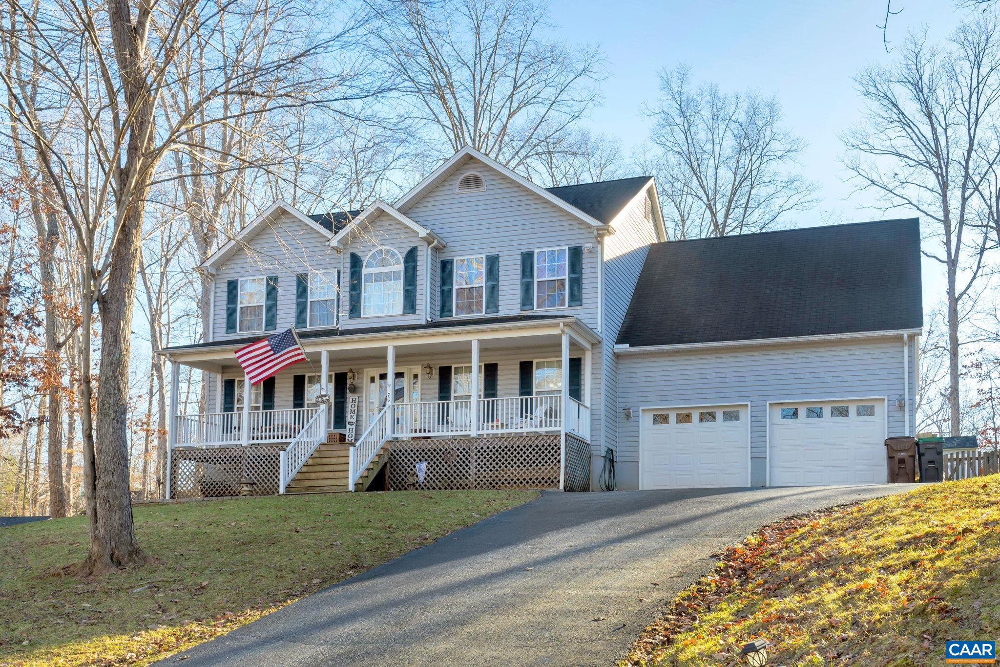 70 Laguna Road Palmyra, VA 22963 - Photo 2 of 33 a front view of a house with a yard and garage