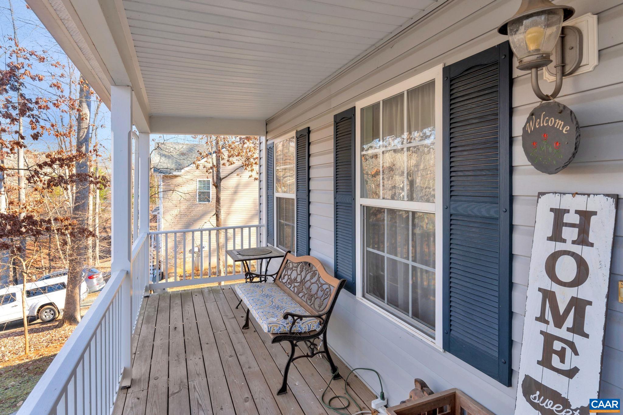 70 Laguna Road Palmyra, VA 22963 - Photo 4 of 33 a view of a balcony with chairs and wooden floor