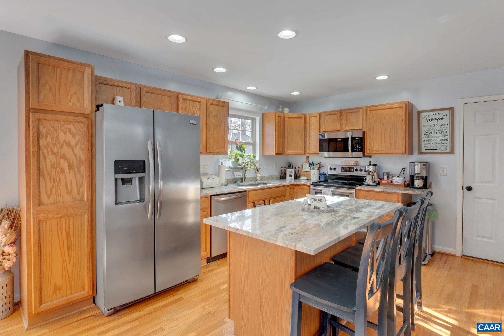 70 Laguna Road Palmyra, VA 22963 - Photo 9 of 33 a kitchen with stainless steel appliances granite countertop a refrigerator a stove a sink a table and chairs