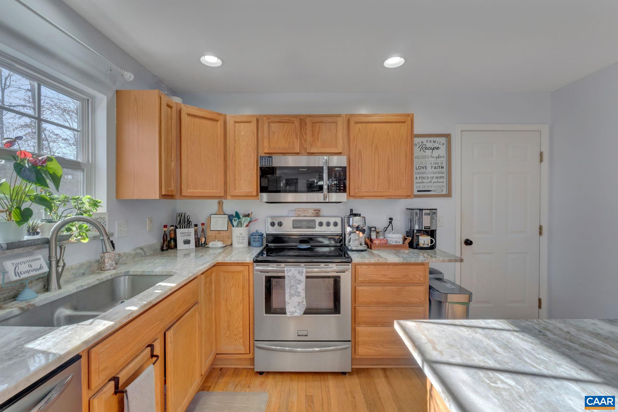 70 Laguna Road Palmyra, VA 22963 - Photo 10 of 33 a kitchen with stainless steel appliances granite countertop a stove a sink and a microwave