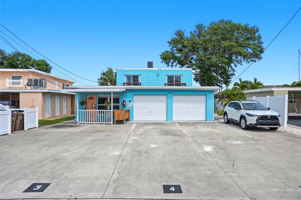 2311 Bay Boulevard Indian Rocks Beach, FL 33785 - Photo 77 of 80 a view of a house with large space and a car parked in front of it