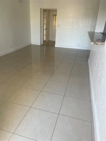 a view of an empty room and entryway