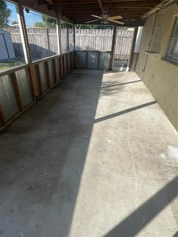 a view of a utility room with white tiles