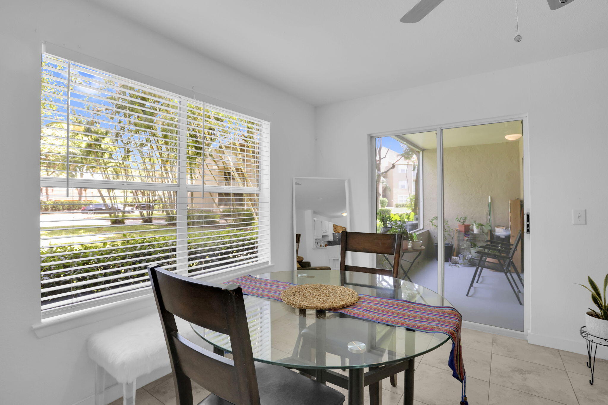 1825 Palm Cove Boulevard, Unit 7102 Delray Beach, FL 33445 - Photo 11 of 19 a view of a dining room with furniture and wooden floor