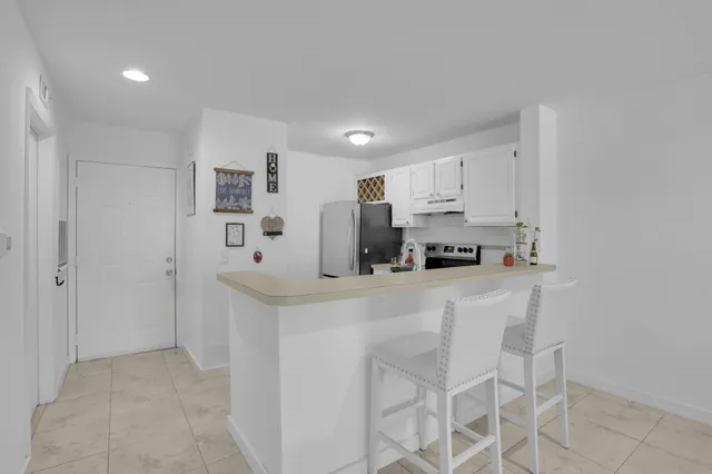 a kitchen with stainless steel appliances a refrigerator and a stove top oven