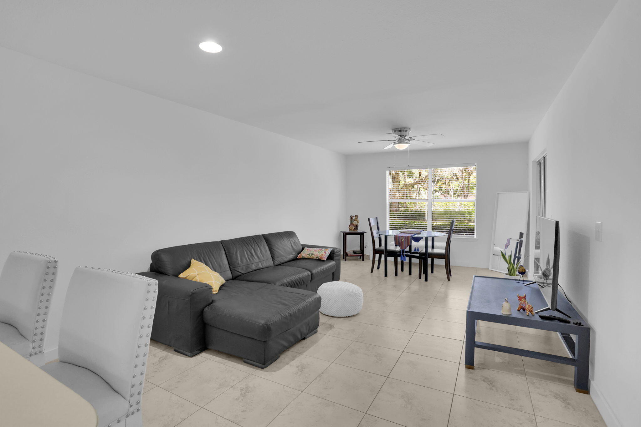 1825 Palm Cove Boulevard, Unit 7102 Delray Beach, FL 33445 - Photo 16 of 19 a living room with furniture and a flat screen tv