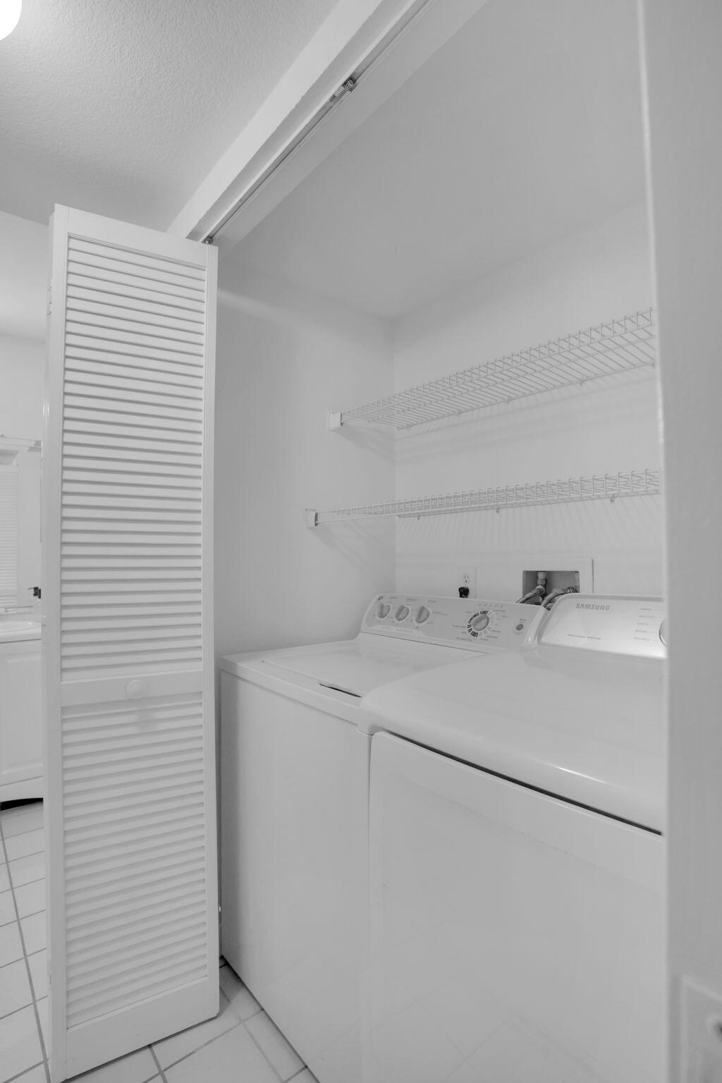 1825 Palm Cove Boulevard, Unit 7102 Delray Beach, FL 33445 - Photo 19 of 19 a utility room with dryer and washer