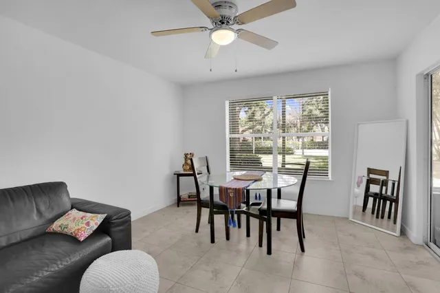 a view of a dining room with furniture and a chandelier