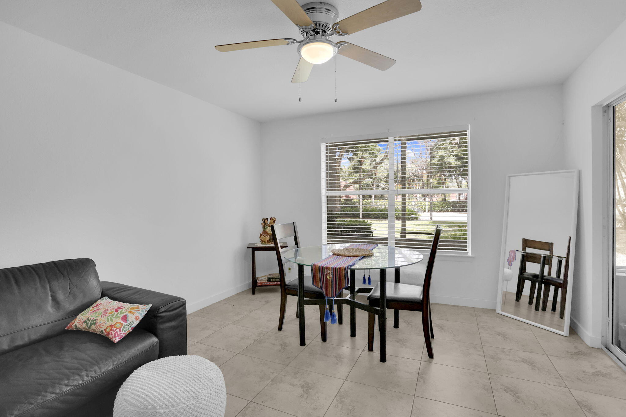 1825 Palm Cove Boulevard, Unit 7102 Delray Beach, FL 33445 - Photo 10 of 19 a view of a dining room with furniture and a chandelier