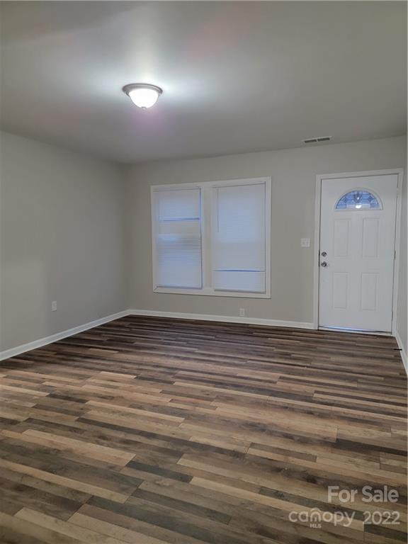 1560 Rainey Road Salisbury, NC 28146 - Photo 15 of 19 an empty room with wooden floor and windows