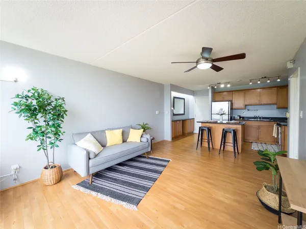 a living room with furniture and a kitchen view