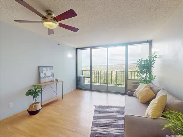 a living room with furniture and a potted plant