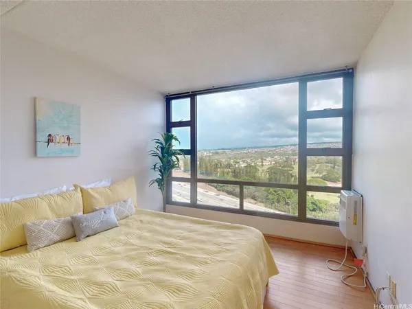 a bedroom with a large bed and a large window