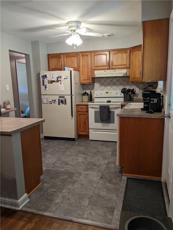 223 S Trail Butler, PA 16002 - Photo 5 of 24 a kitchen with a stove a sink and a microwave