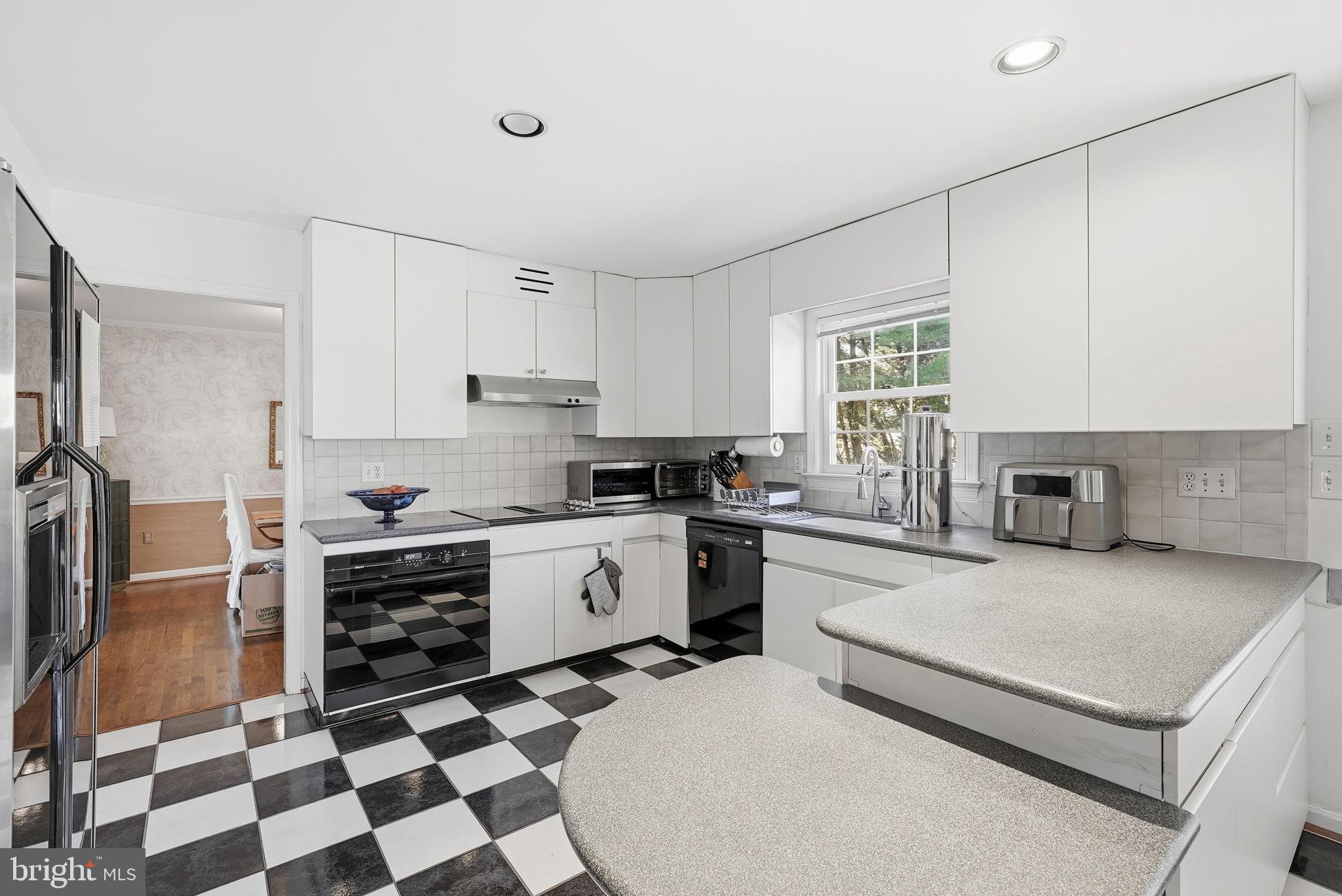 13621 North Gate Drive Silver Spring, MD 20906 - Photo 13 of 54 a kitchen with stainless steel appliances granite countertop a stove a sink and a refrigerator