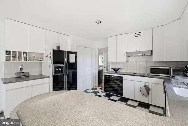 a kitchen with stainless steel appliances a stove a refrigerator and a refrigerator