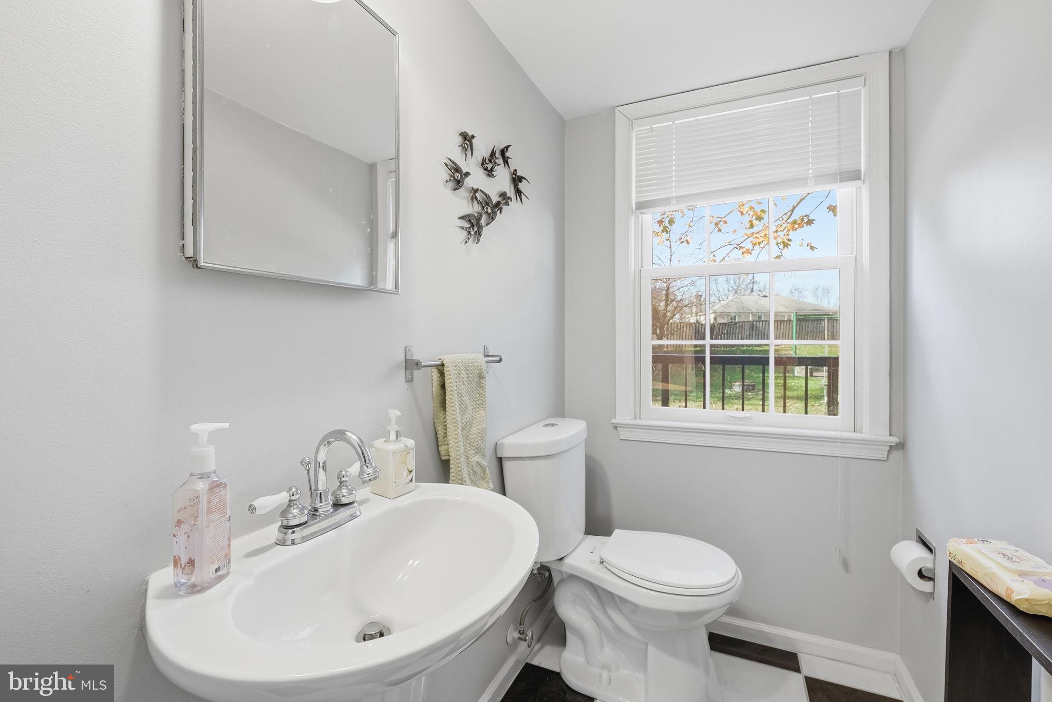 13621 North Gate Drive Silver Spring, MD 20906 - Photo 18 of 54 a bathroom with a sink a toilet and a mirror