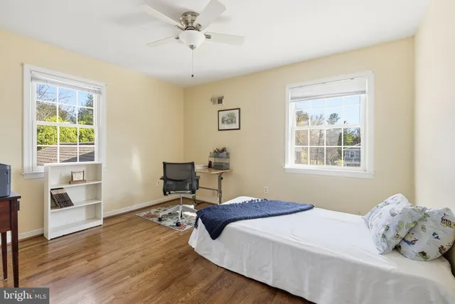 a bedroom with a bed a desk and chair