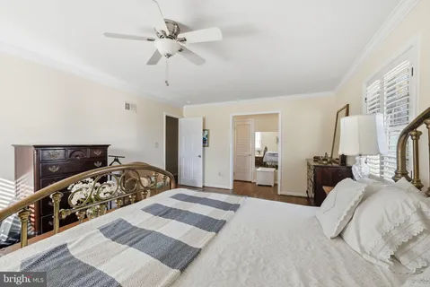 a bedroom with a bed and a mirror on dresser