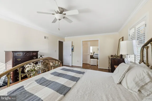 a bedroom with a bed and a mirror on dresser