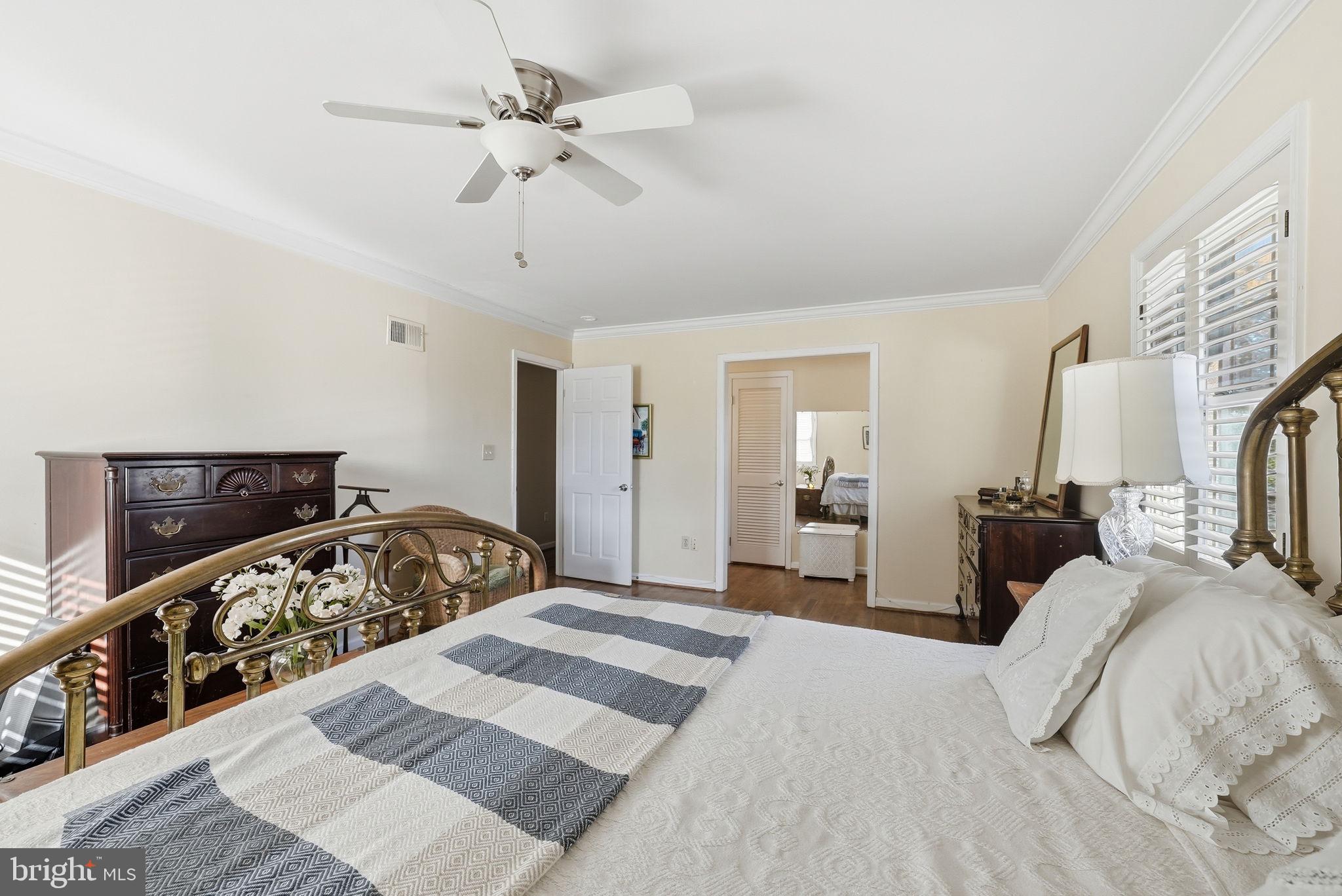 13621 North Gate Drive Silver Spring, MD 20906 - Photo 25 of 54 a bedroom with a bed and a chandelier