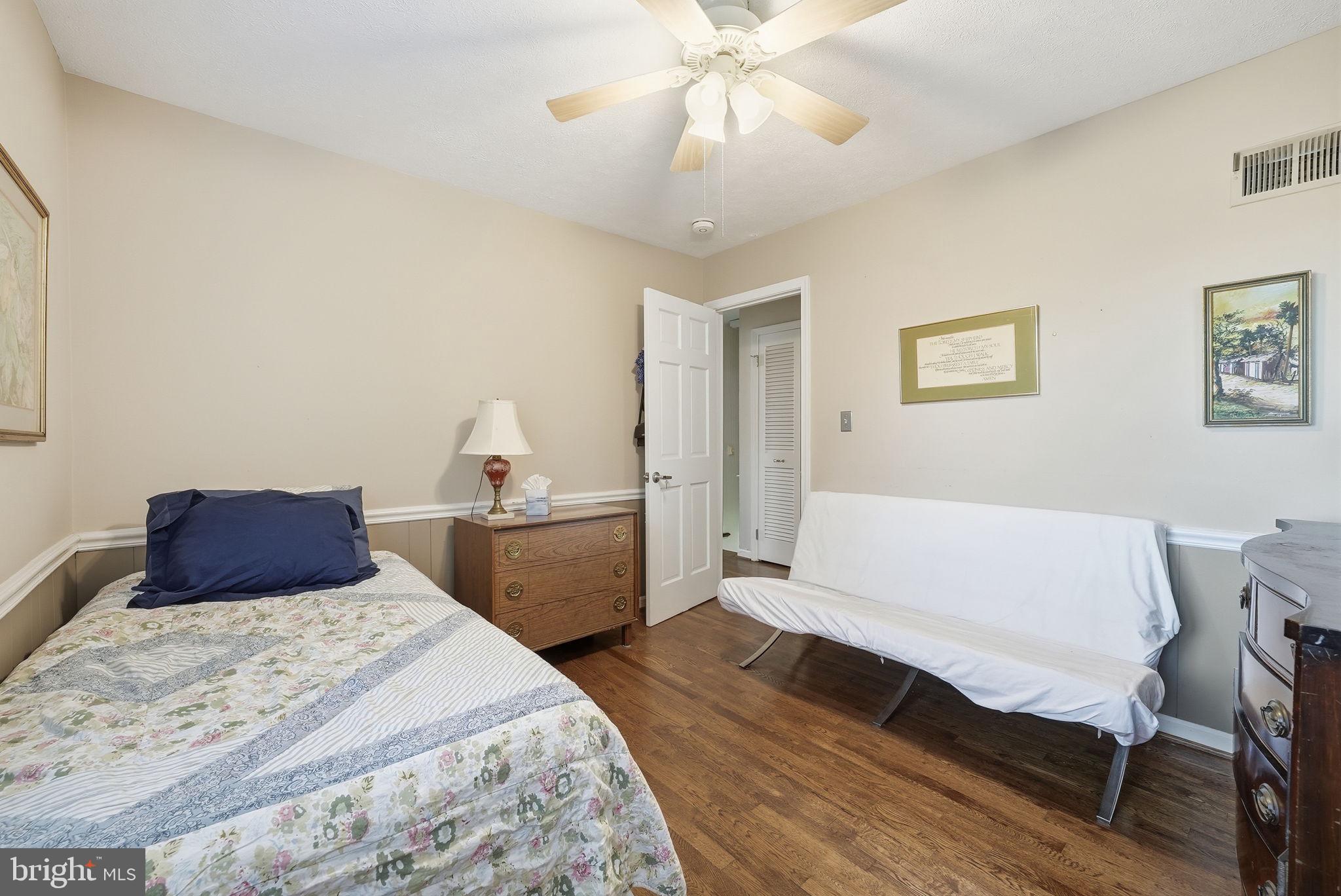 13621 North Gate Drive Silver Spring, MD 20906 - Photo 29 of 54 a bedroom with a large bed and a chandelier