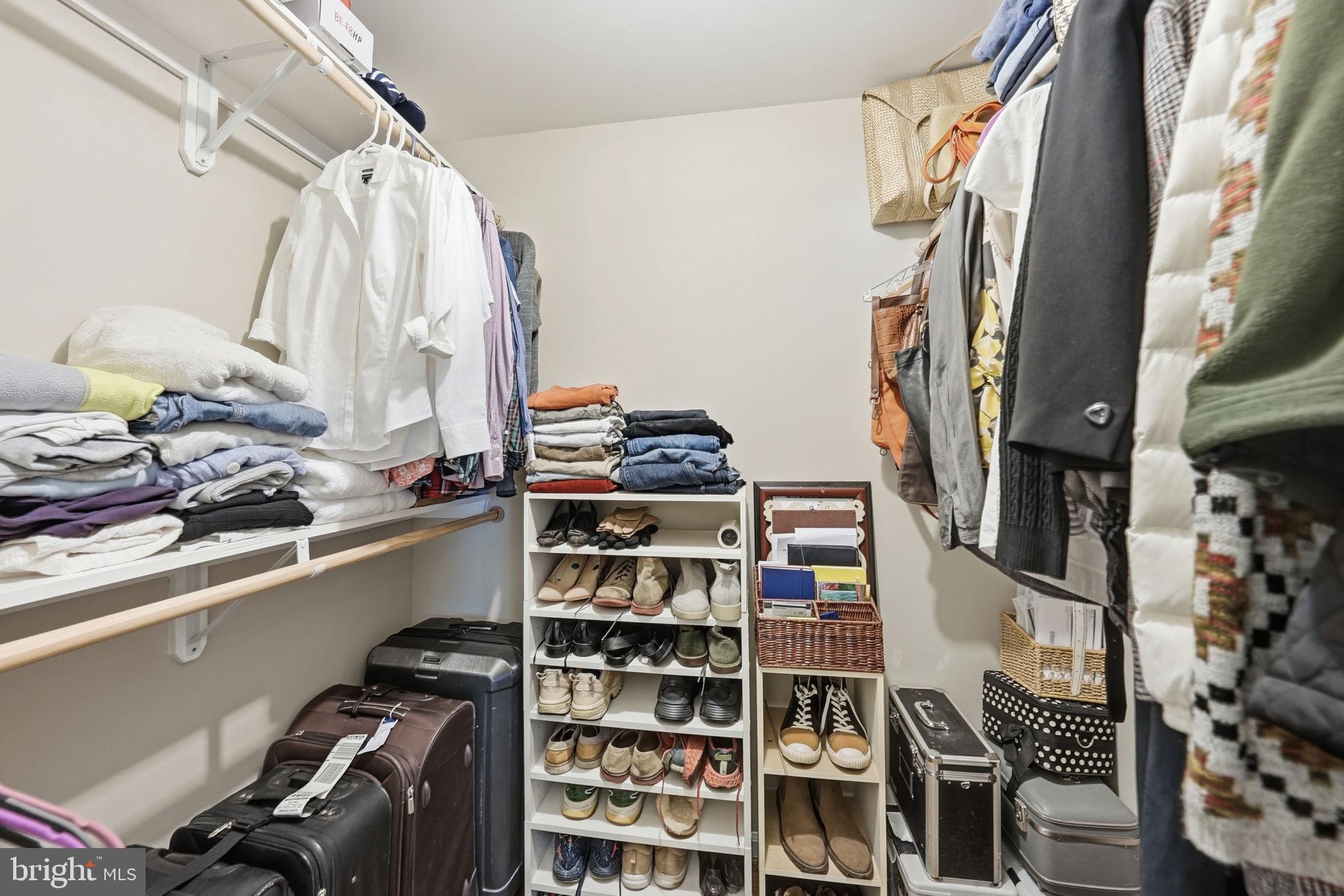 13621 North Gate Drive Silver Spring, MD 20906 - Photo 32 of 54 a view of walk in closet with clothes and shoes