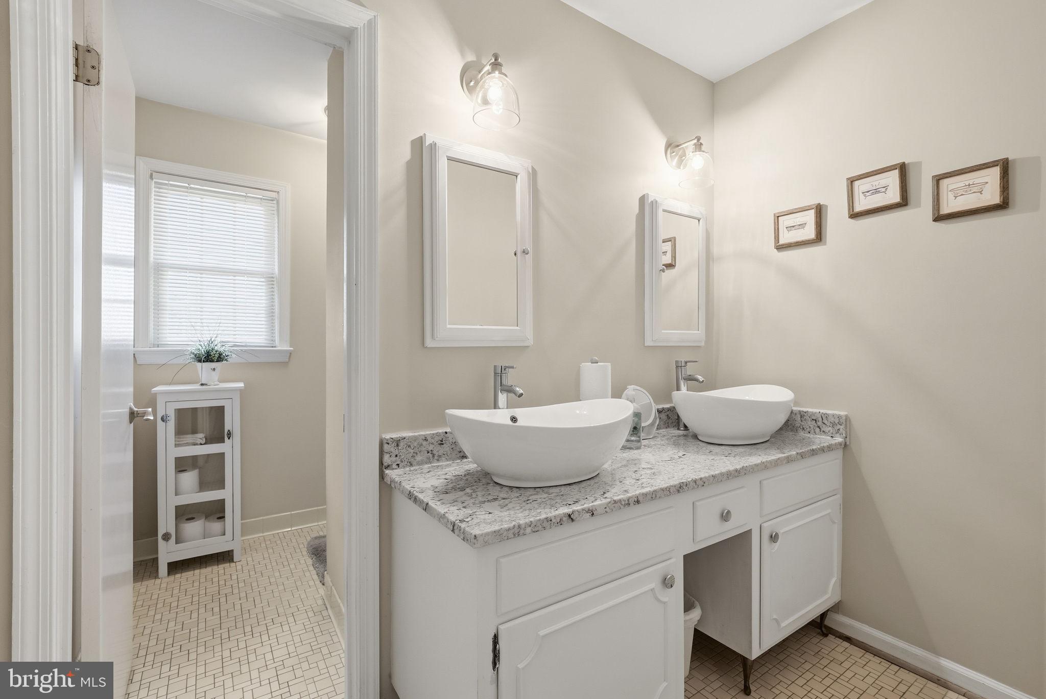 13621 North Gate Drive Silver Spring, MD 20906 - Photo 33 of 54 a bathroom with a granite countertop sink and a mirror