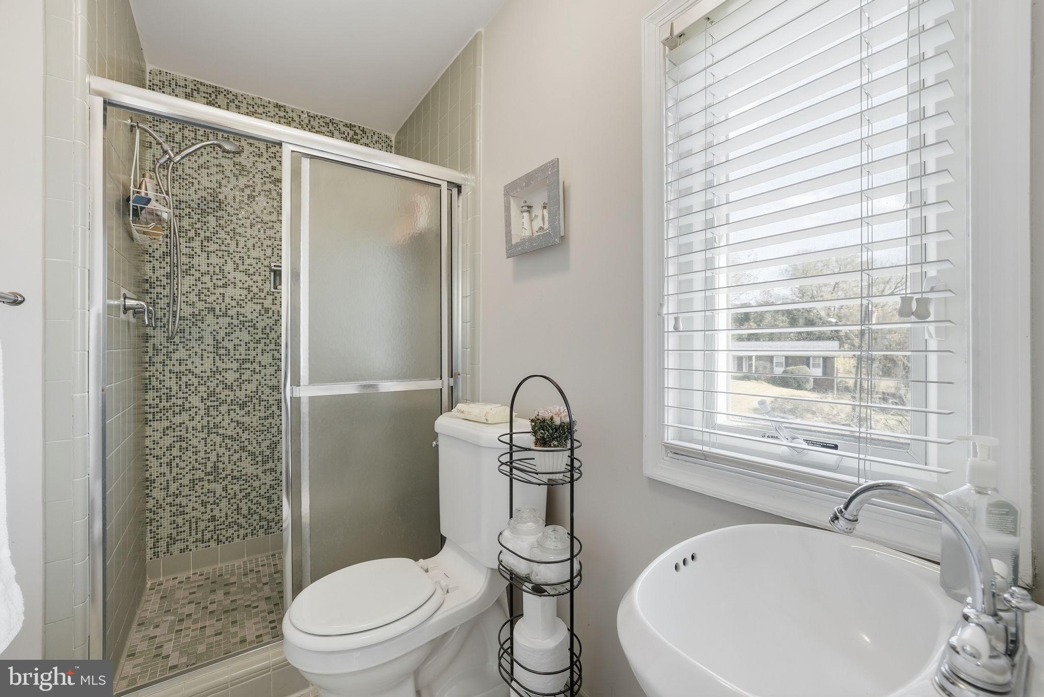 13621 North Gate Drive Silver Spring, MD 20906 - Photo 35 of 54 a bathroom with a sink toilet and shower