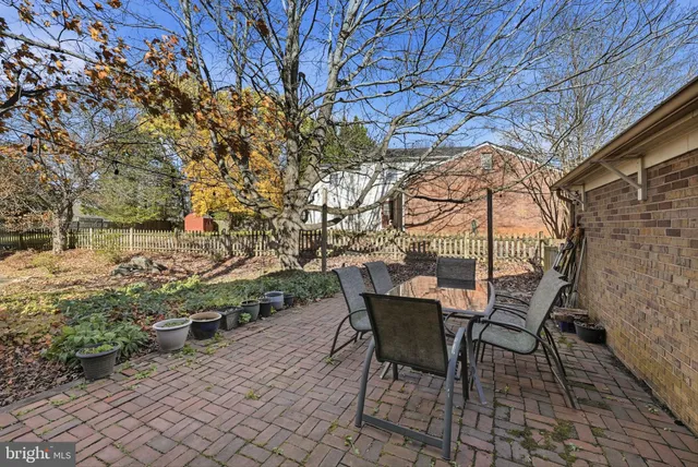 a kitchen with a sink a stove a refrigerator cabinets and a dining table