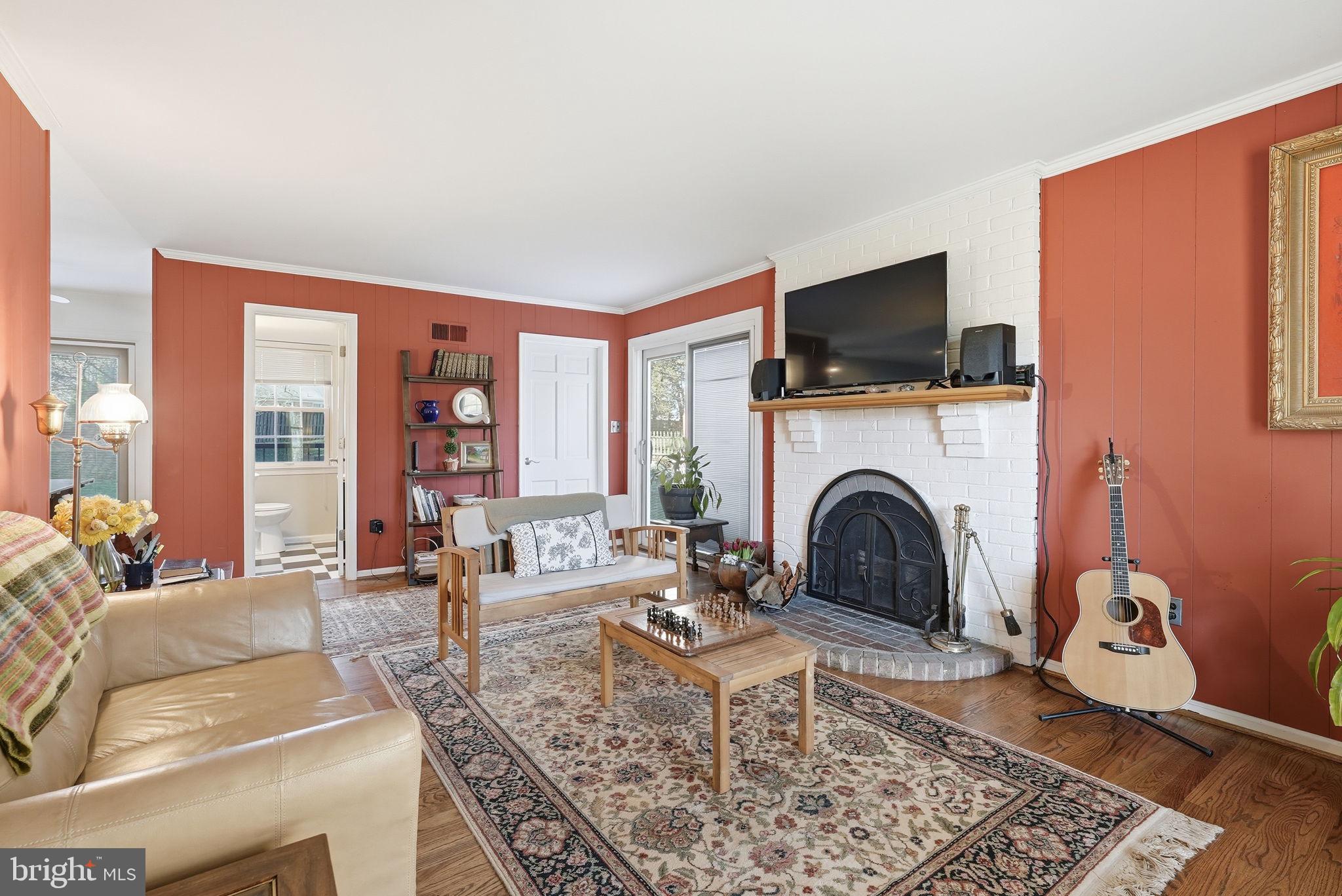 13621 North Gate Drive Silver Spring, MD 20906 - Photo 5 of 54 a living room with furniture a flat screen tv and a fireplace