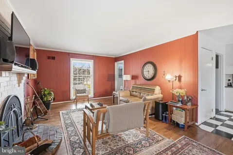 a living room with furniture a rug and a window