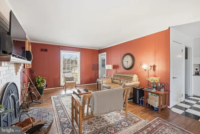 a living room with furniture a rug and a window