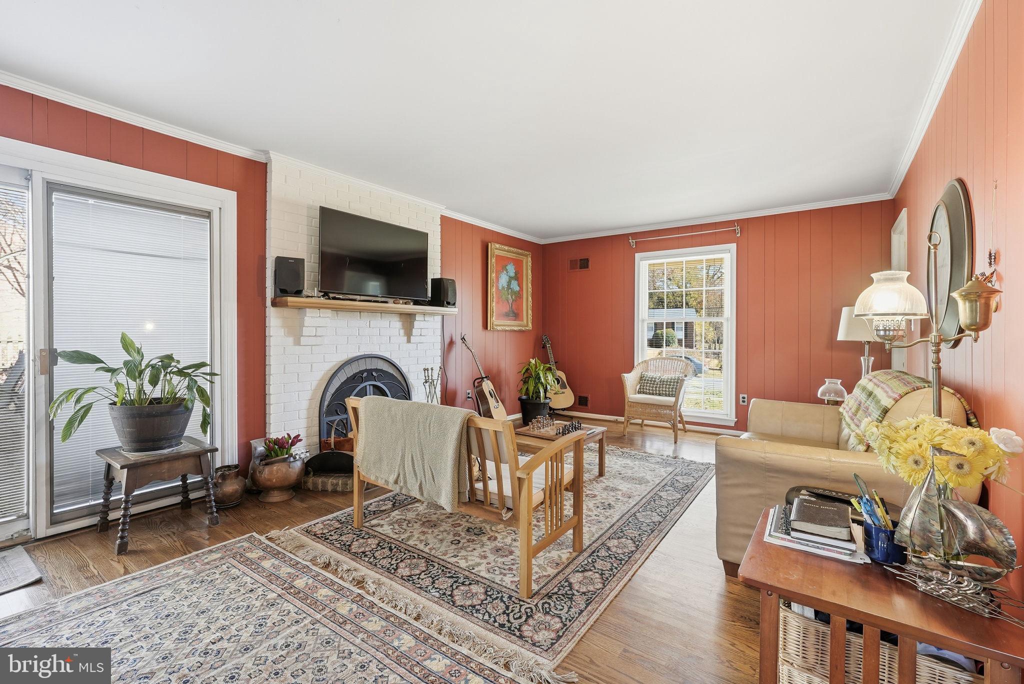 13621 North Gate Drive Silver Spring, MD 20906 - Photo 7 of 54 a living room with furniture a flat screen tv and a fireplace