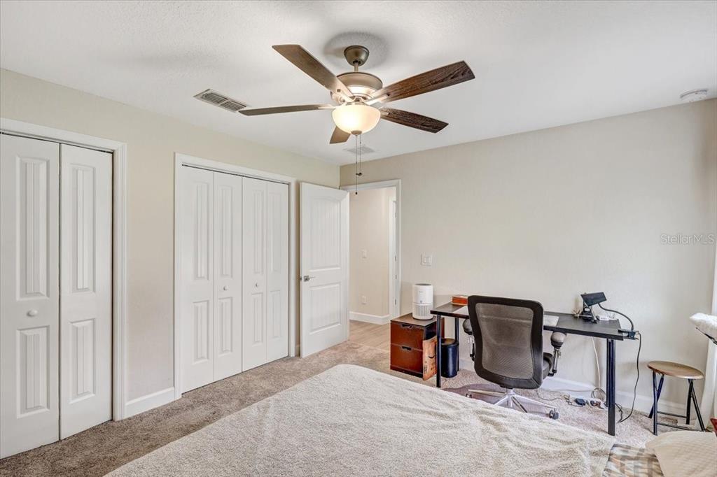 7314 Madrid Road Weeki Wachee, FL 34613 - Photo 23 of 54 a bedroom with furniture and a ceiling fan