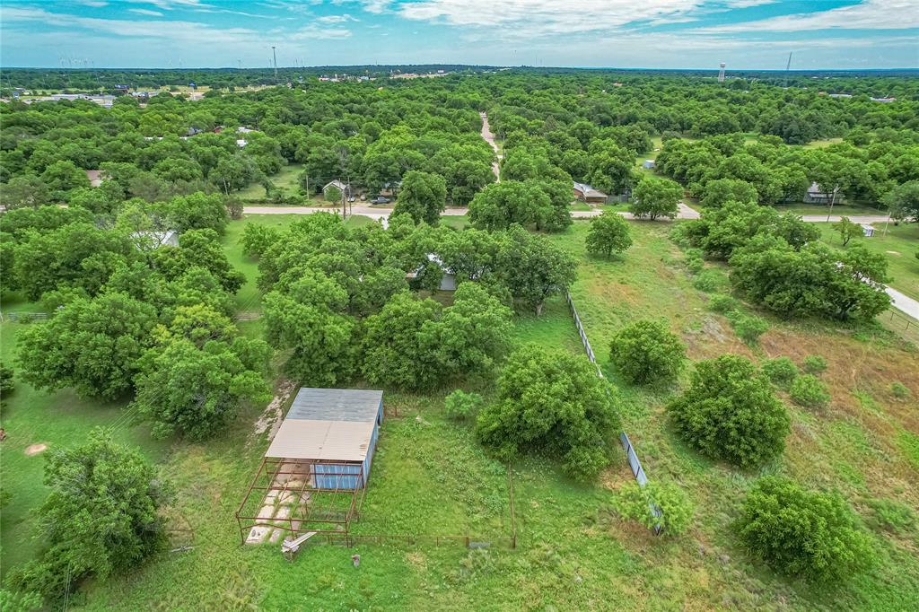 510 Hamby Road Clyde, TX 79510 - Photo 9 of 34 Expansive land parcel featuring a metal-roofed outbuilding with a fenced enclosure