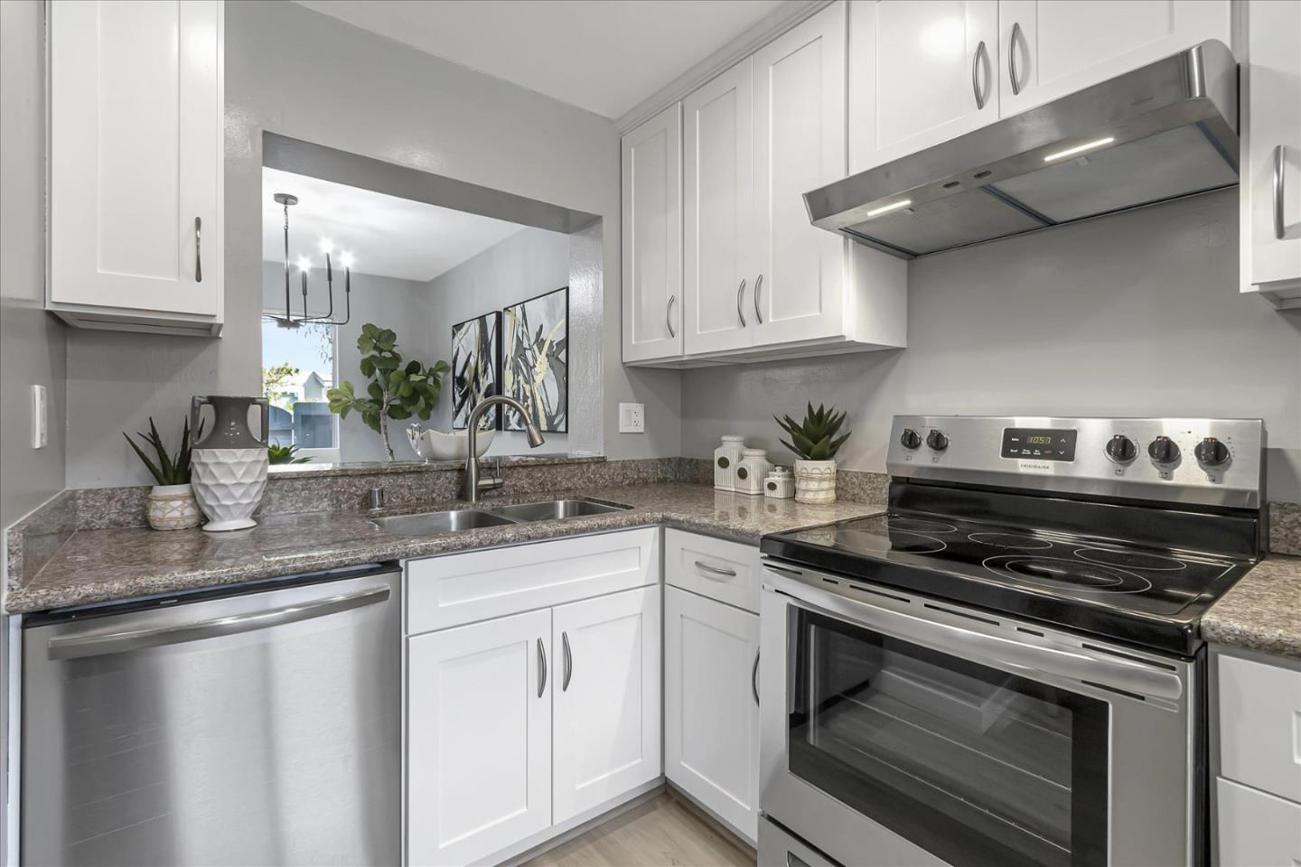 4796 Raspberry Place San Jose, CA 95129 - Photo 12 of 37 a kitchen with stainless steel appliances granite countertop a sink stove and cabinets
