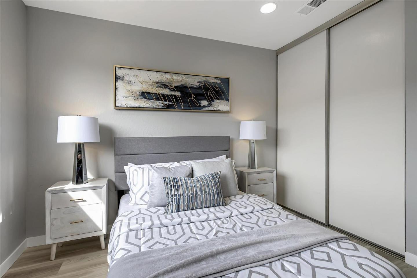 4796 Raspberry Place San Jose, CA 95129 - Photo 22 of 37 a bedroom with a bed and a lamp on table