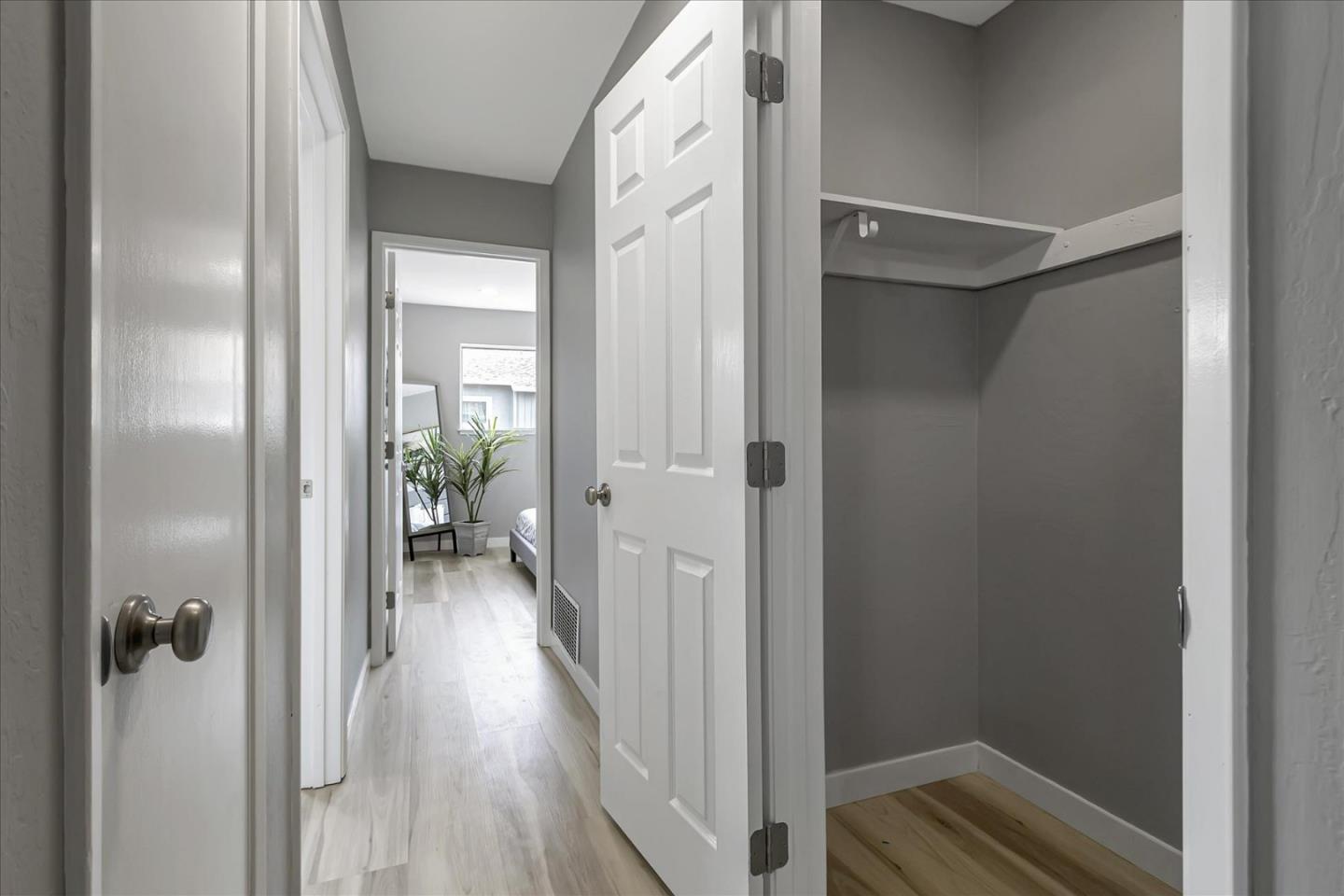 4796 Raspberry Place San Jose, CA 95129 - Photo 23 of 37 a view of a hallway with wooden floor and a bathroom