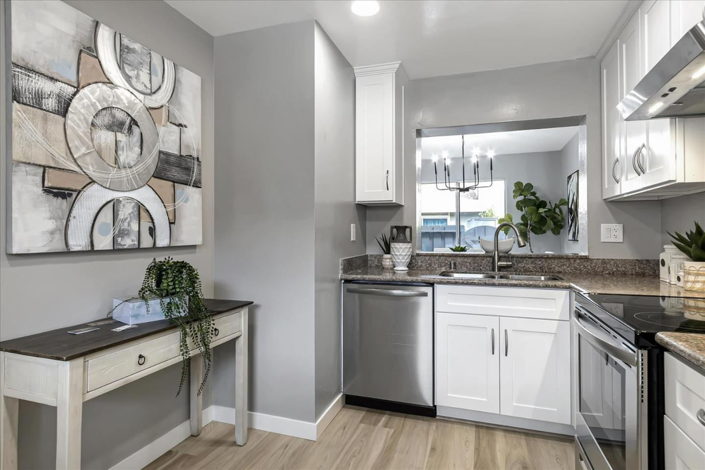 4796 Raspberry Place San Jose, CA 95129 - Photo 10 of 37 a kitchen with stainless steel appliances granite countertop a sink and a stove