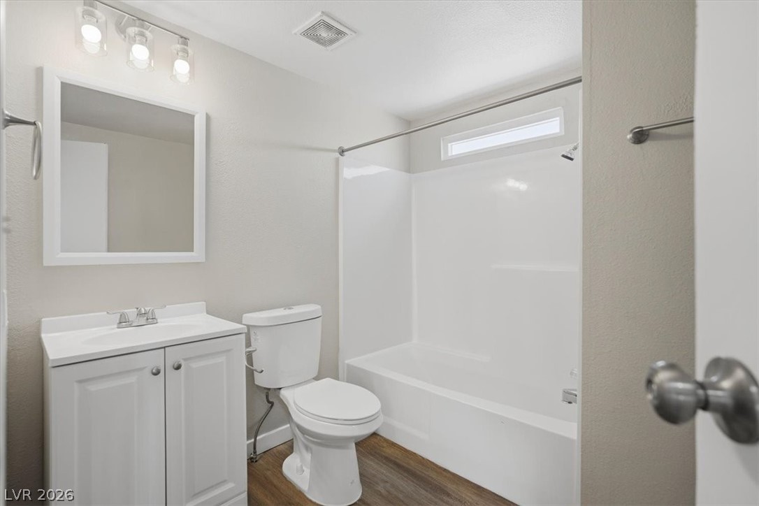 283 Aztec Lane Henderson, NV 89015 - Photo 14 of 21 A well-appointed bathroom offers contemporary fixtures and wood-look flooring.